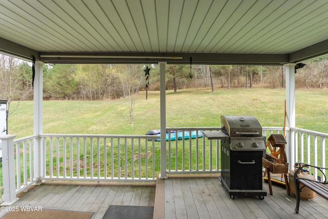 deck with grilling area and a lawn