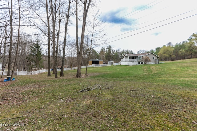 view of yard with an outbuilding and fence
