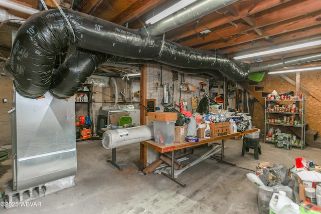unfinished basement with washer and clothes dryer