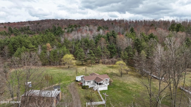 drone / aerial view with a wooded view