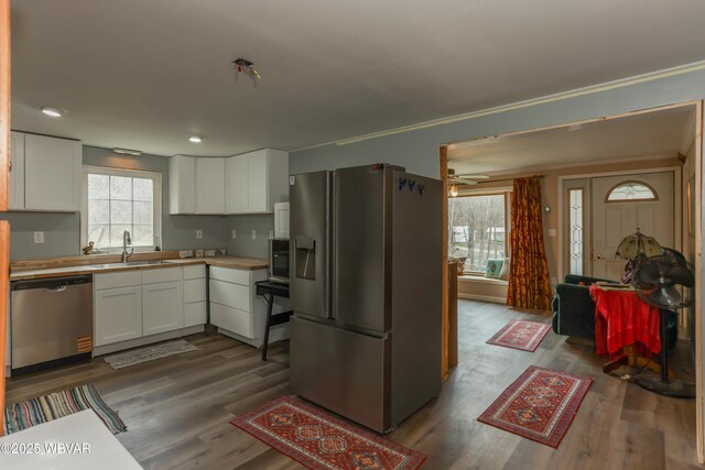 office featuring a ceiling fan, wood finished floors, and crown molding