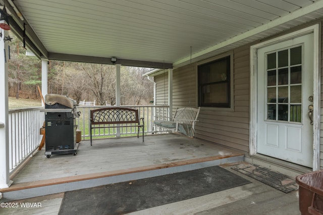 deck with grilling area and a porch