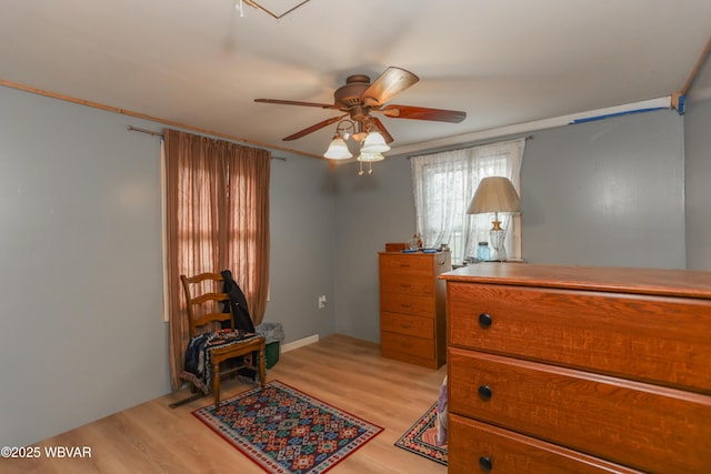 bedroom featuring a ceiling fan and light wood finished floors