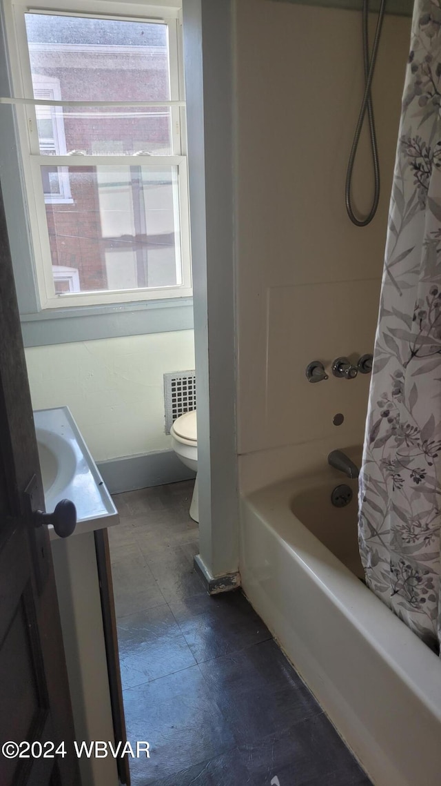 full bathroom with radiator, vanity, shower / tub combo, and toilet