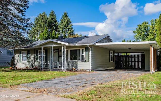 ranch-style home with covered porch, a front lawn, and a carport