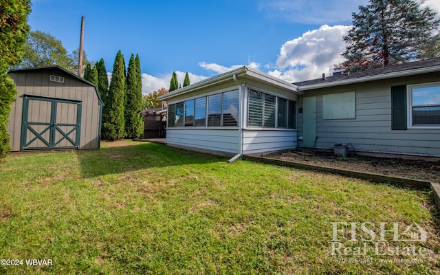 exterior space featuring a yard and a storage unit