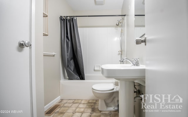 bathroom with toilet and shower / bath combo with shower curtain