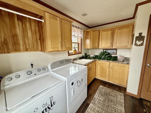 laundry room with ornamental molding, washer and dryer, dark wood-style floors, cabinet space, and a sink