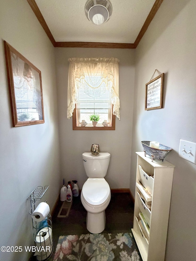 bathroom with visible vents, toilet, and ornamental molding