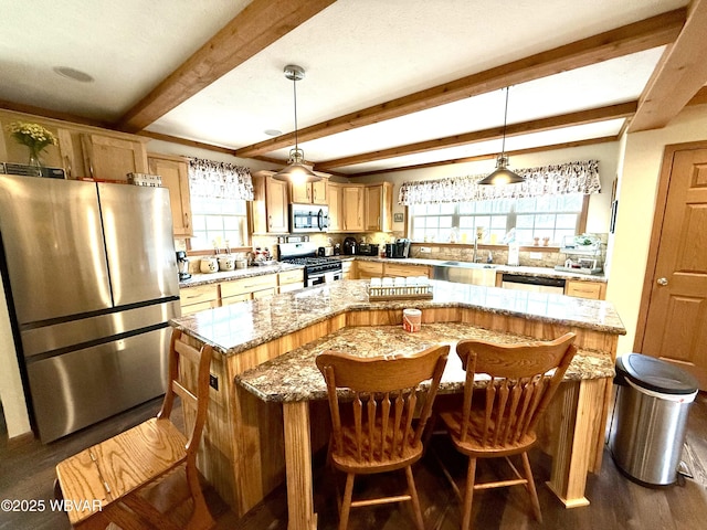 kitchen with a kitchen island, dark wood-type flooring, pendant lighting, beam ceiling, and appliances with stainless steel finishes