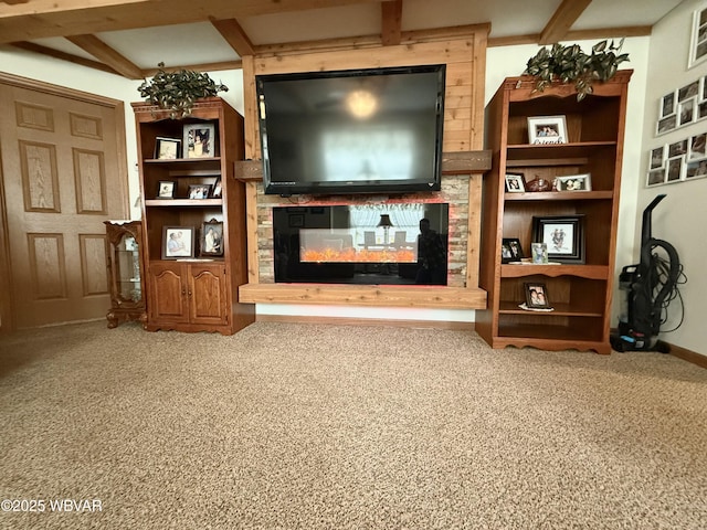 living area featuring beam ceiling, a multi sided fireplace, baseboards, and carpet