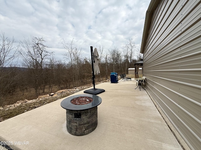 view of patio / terrace featuring an outdoor fire pit