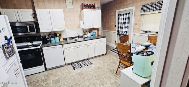 103 Lower Market St, Milton, PA 17847 - kitchen with white appliances, a sink, dark countertops, and white cabinets