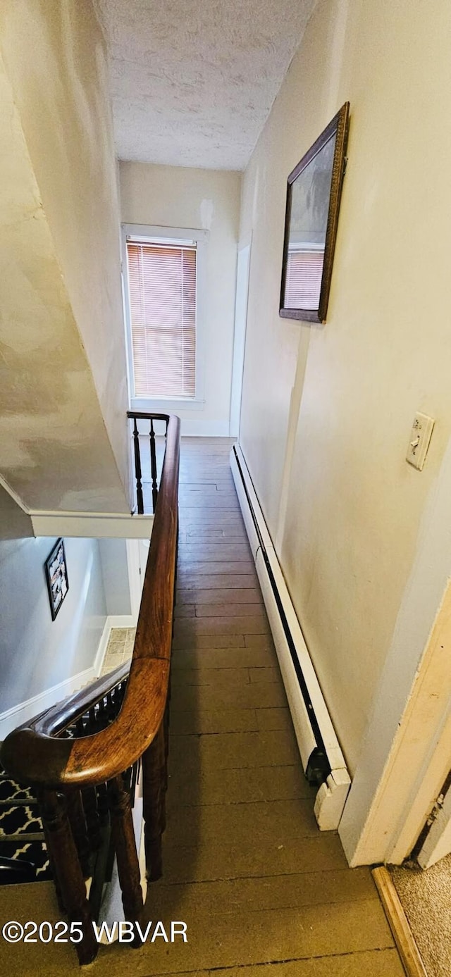 103 Lower Market St, Milton, PA 17847 - hallway featuring hardwood / wood-style floors, a textured ceiling, and a baseboard heating unit