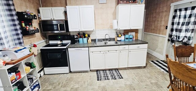 103 Lower Market St, Milton, PA 17847 - kitchen featuring stainless steel microwave, electric stove, white dishwasher, a sink, and dark countertops