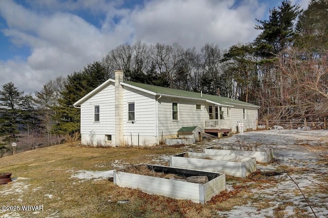 view of home's exterior with a garden