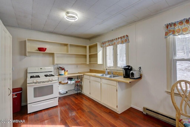 kitchen featuring a baseboard heating unit, light countertops, open shelves, and white gas range oven