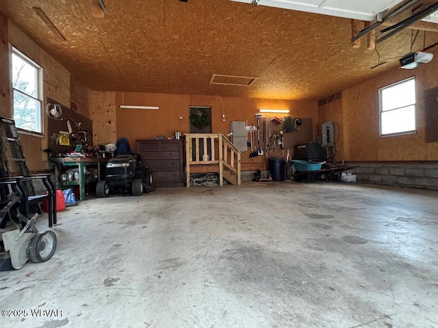 garage with a garage door opener and a workshop area