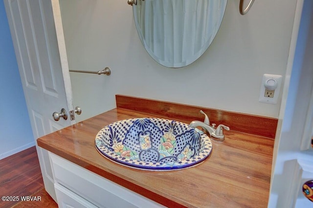 bathroom featuring wood finished floors and vanity