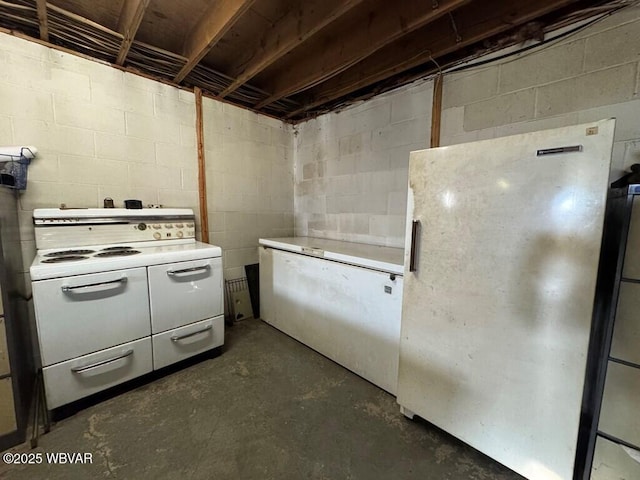 kitchen featuring light countertops, white appliances, and concrete floors