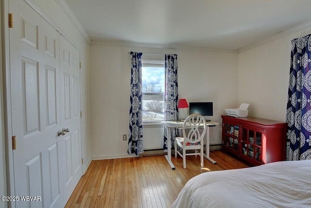 bedroom with crown molding and wood finished floors