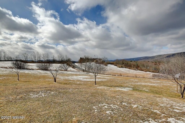 view of yard featuring a rural view and a mountain view