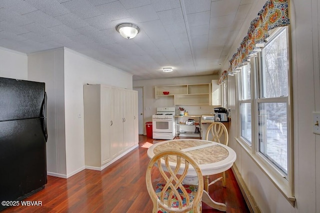 dining space with baseboards and dark wood finished floors