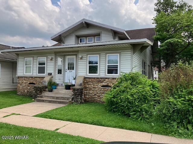 130 N Fairview St, Lock Haven, PA 17745 - bungalow-style home with stone siding and a front lawn