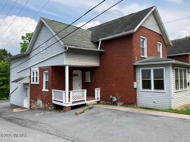 130 N Fairview St, Lock Haven, PA 17745 - view of front of home with covered porch, brick siding, and a shingled roof