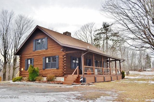 log cabin with covered porch