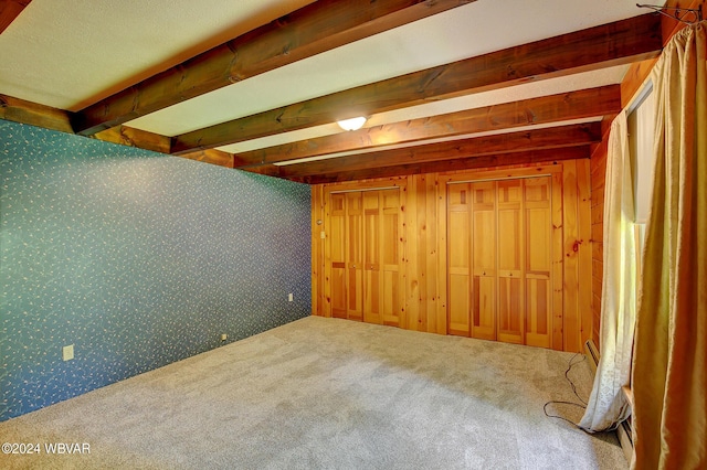 below grade area with carpet floors and wallpapered walls