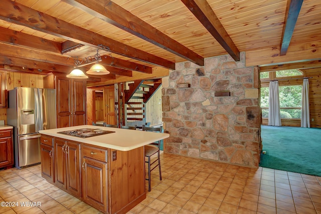 kitchen with cooktop, wood ceiling, light countertops, and stainless steel fridge with ice dispenser