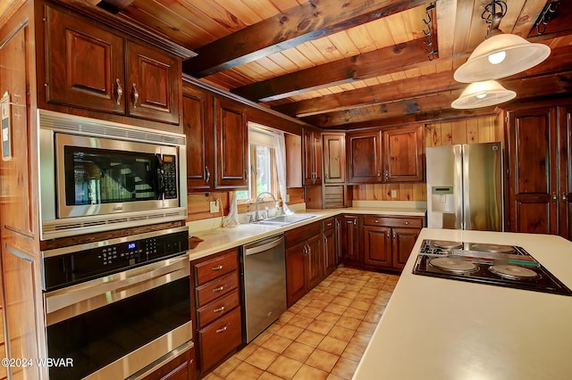 kitchen featuring light tile patterned floors, wooden ceiling, appliances with stainless steel finishes, light countertops, and a sink