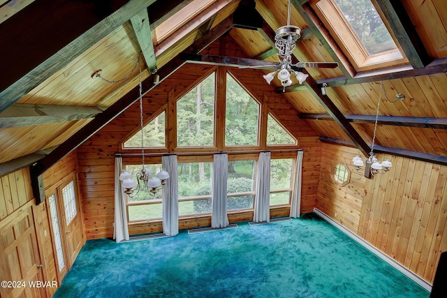 interior space featuring wood walls, carpet, and an inviting chandelier