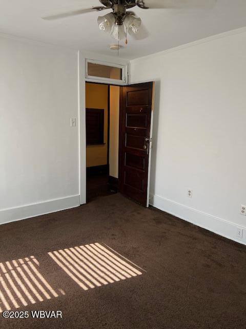 unfurnished room with baseboards, carpet flooring, ceiling fan, and ornamental molding