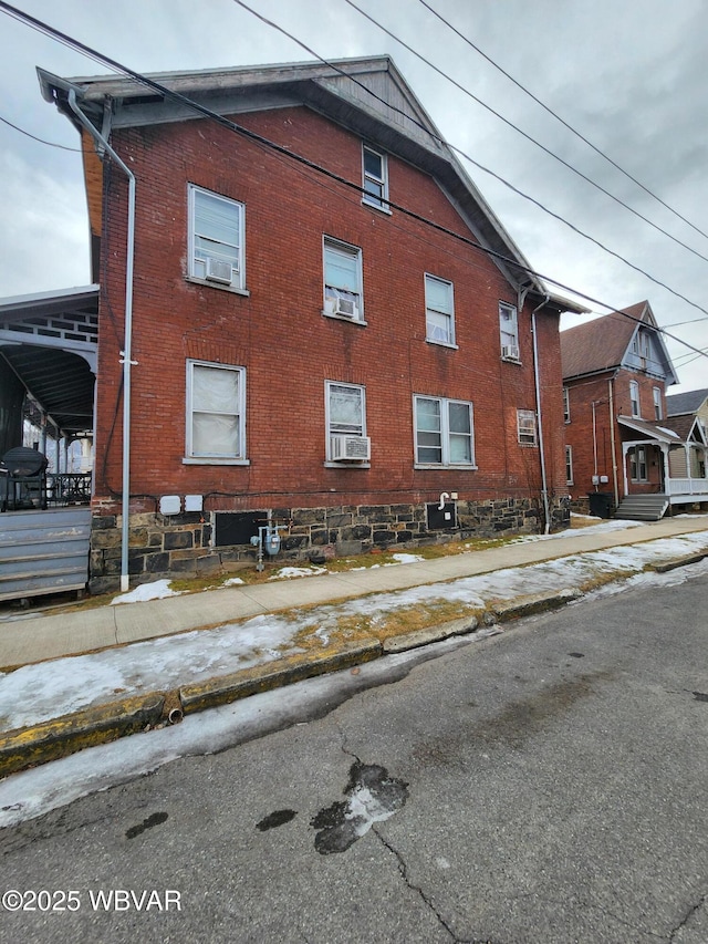 view of home's exterior featuring cooling unit and brick siding