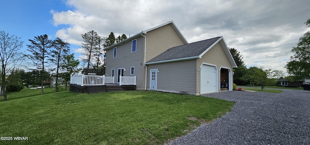 250 Mclaughlin Rd, Milton, PA 17847 - back of house with a wooden deck, a yard, gravel driveway, and a garage