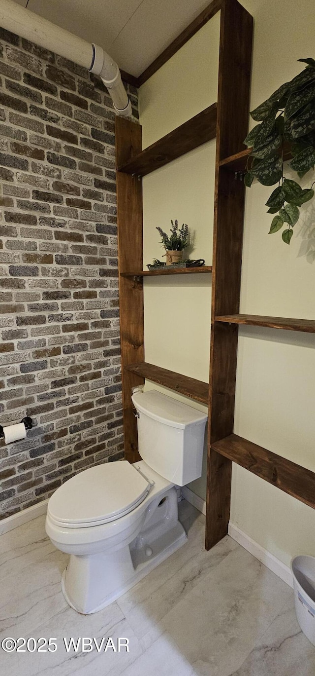 250 Mclaughlin Rd, Milton, PA 17847 - bathroom with toilet, brick wall, and baseboards