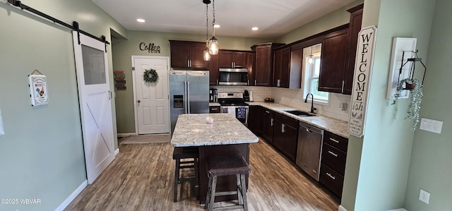250 Mclaughlin Rd, Milton, PA 17847 - kitchen with stainless steel appliances, a sink, dark brown cabinets, backsplash, and light wood finished floors