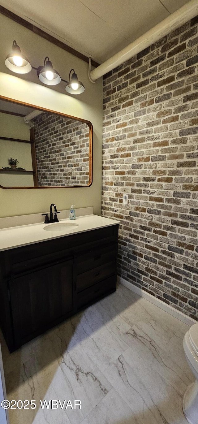 250 Mclaughlin Rd, Milton, PA 17847 - bathroom featuring brick wall, marble finish floors, vanity, and toilet