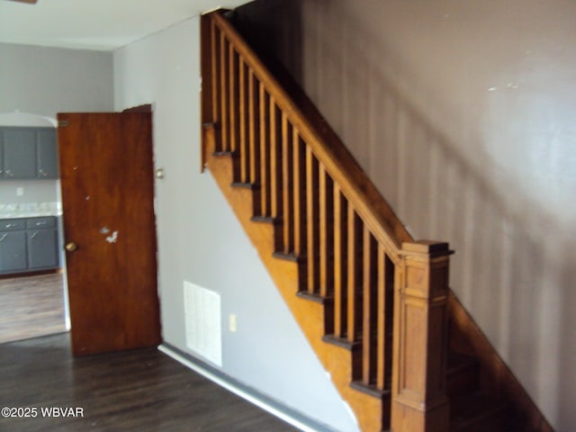 staircase with wood finished floors and visible vents