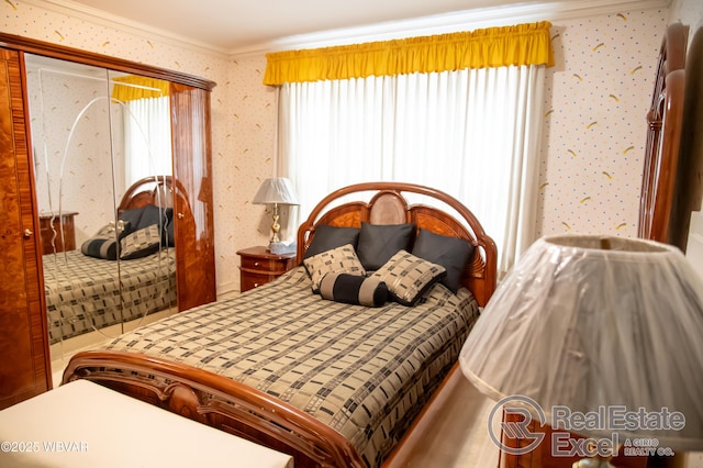 bedroom with ornamental molding and a closet