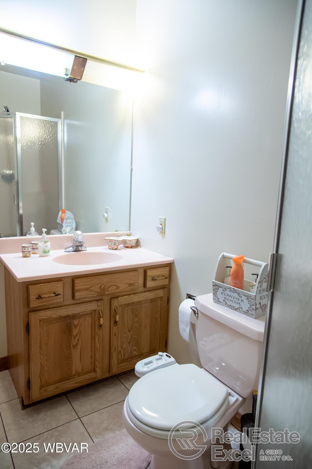 bathroom featuring vanity, toilet, a shower with shower door, and tile patterned flooring