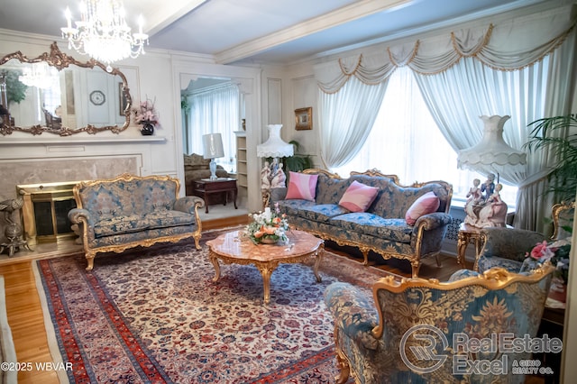 living room with hardwood / wood-style flooring, crown molding, and an inviting chandelier