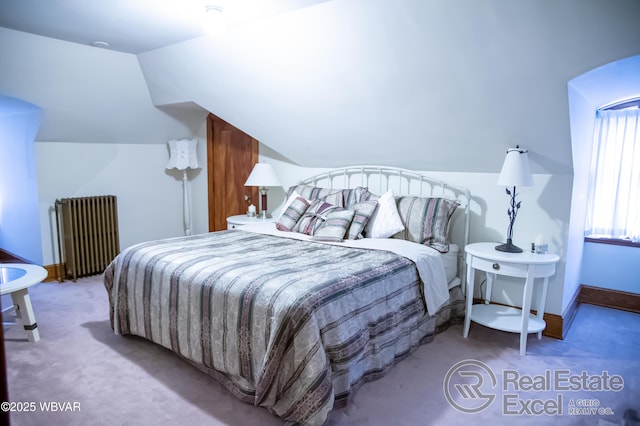 carpeted bedroom featuring lofted ceiling and radiator