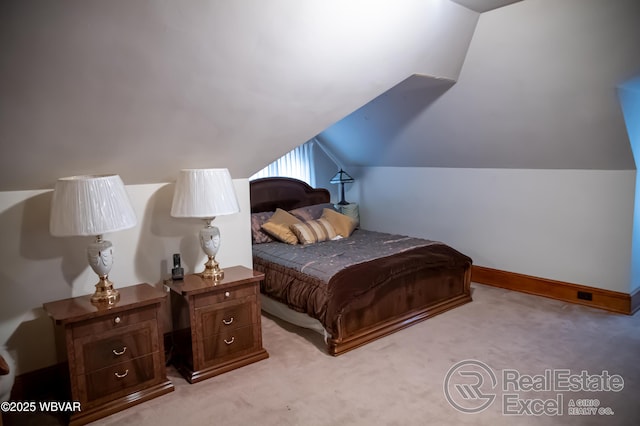 carpeted bedroom featuring lofted ceiling