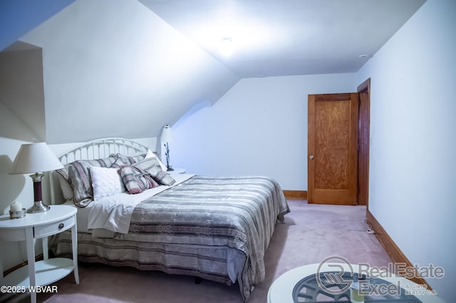 bedroom with lofted ceiling and light colored carpet