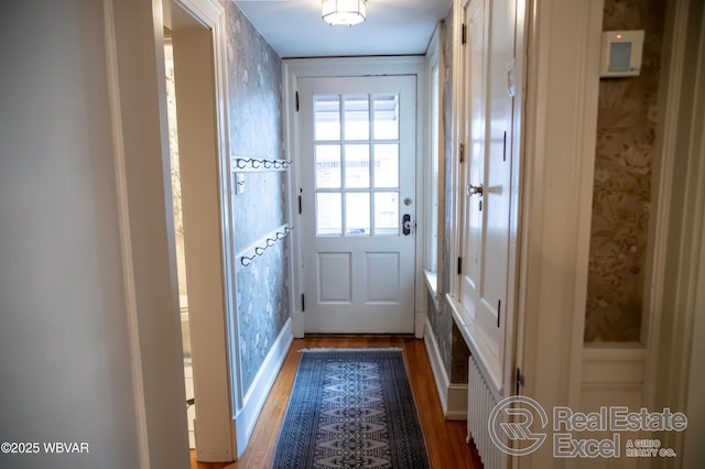 doorway to outside with wood-type flooring