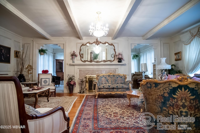 living area with beam ceiling, crown molding, hardwood / wood-style floors, and a chandelier