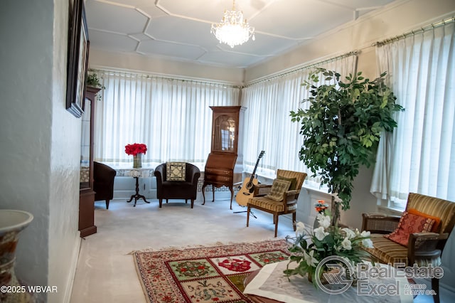 living area with light carpet, a notable chandelier, and a wealth of natural light